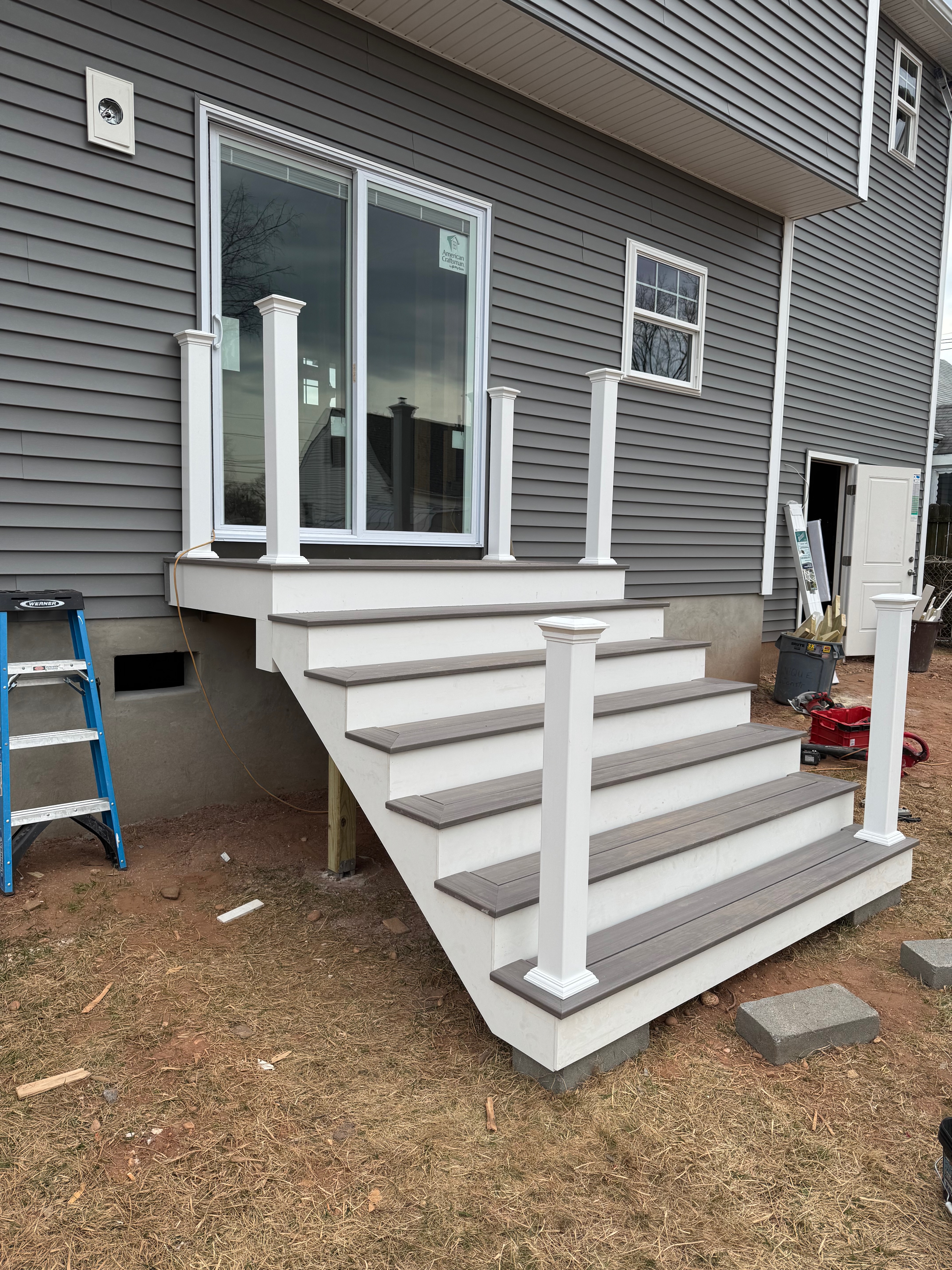 Exterior deck — composite decking with white railings and stairs