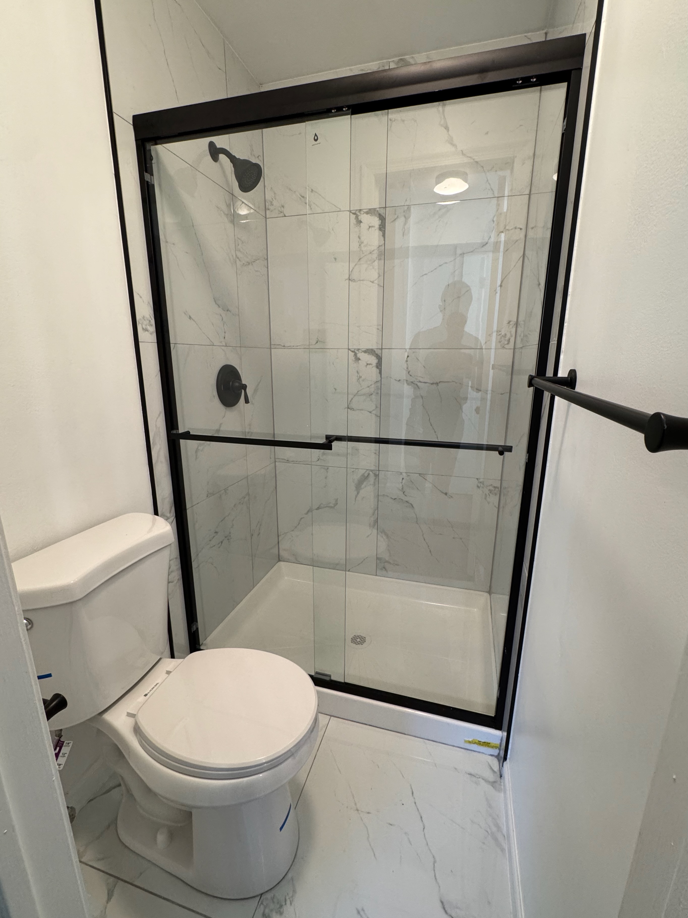 Bathroom remodel — marble tile and black frame glass shower