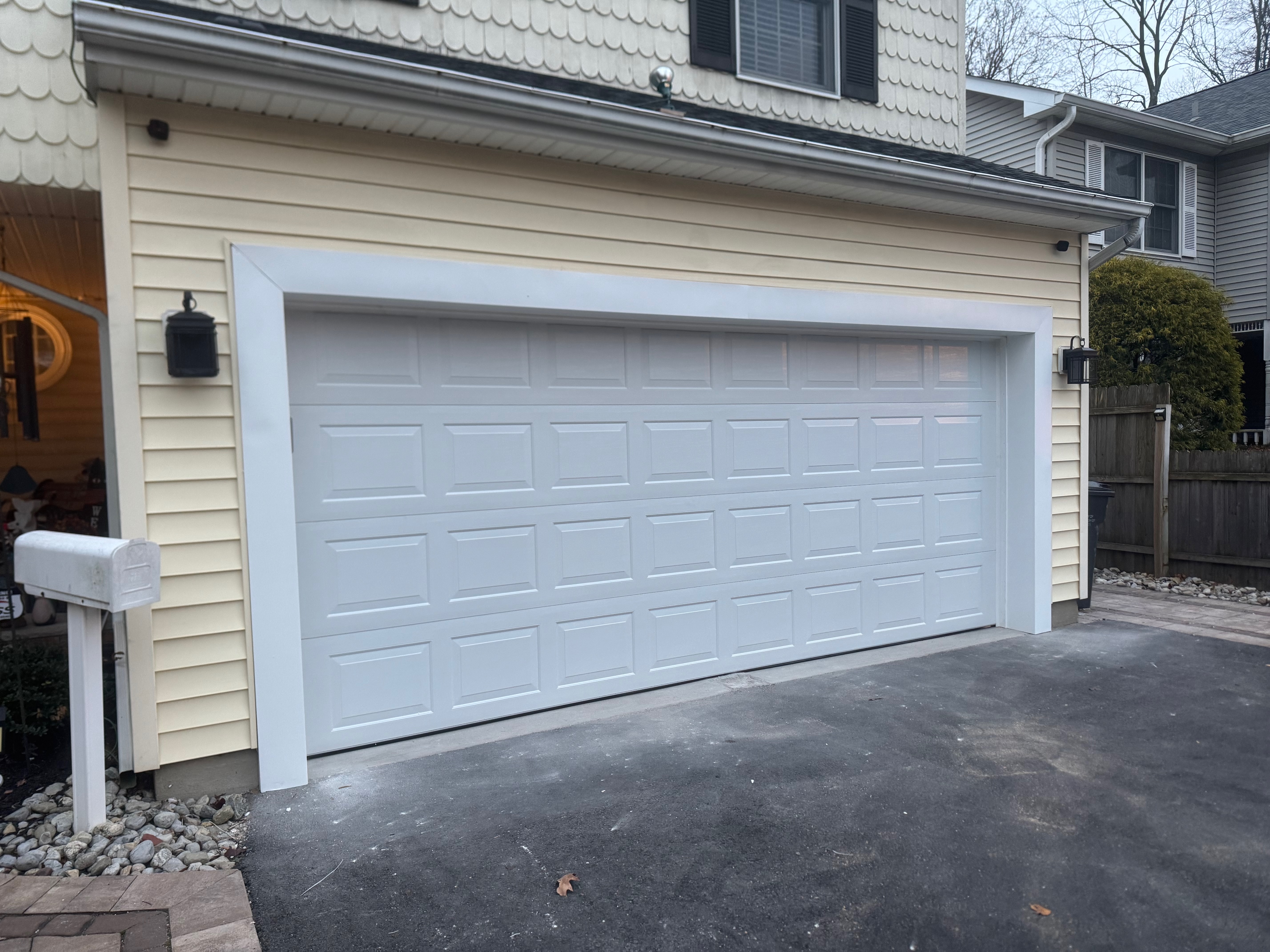 Garage door replacement — new white double panel doors