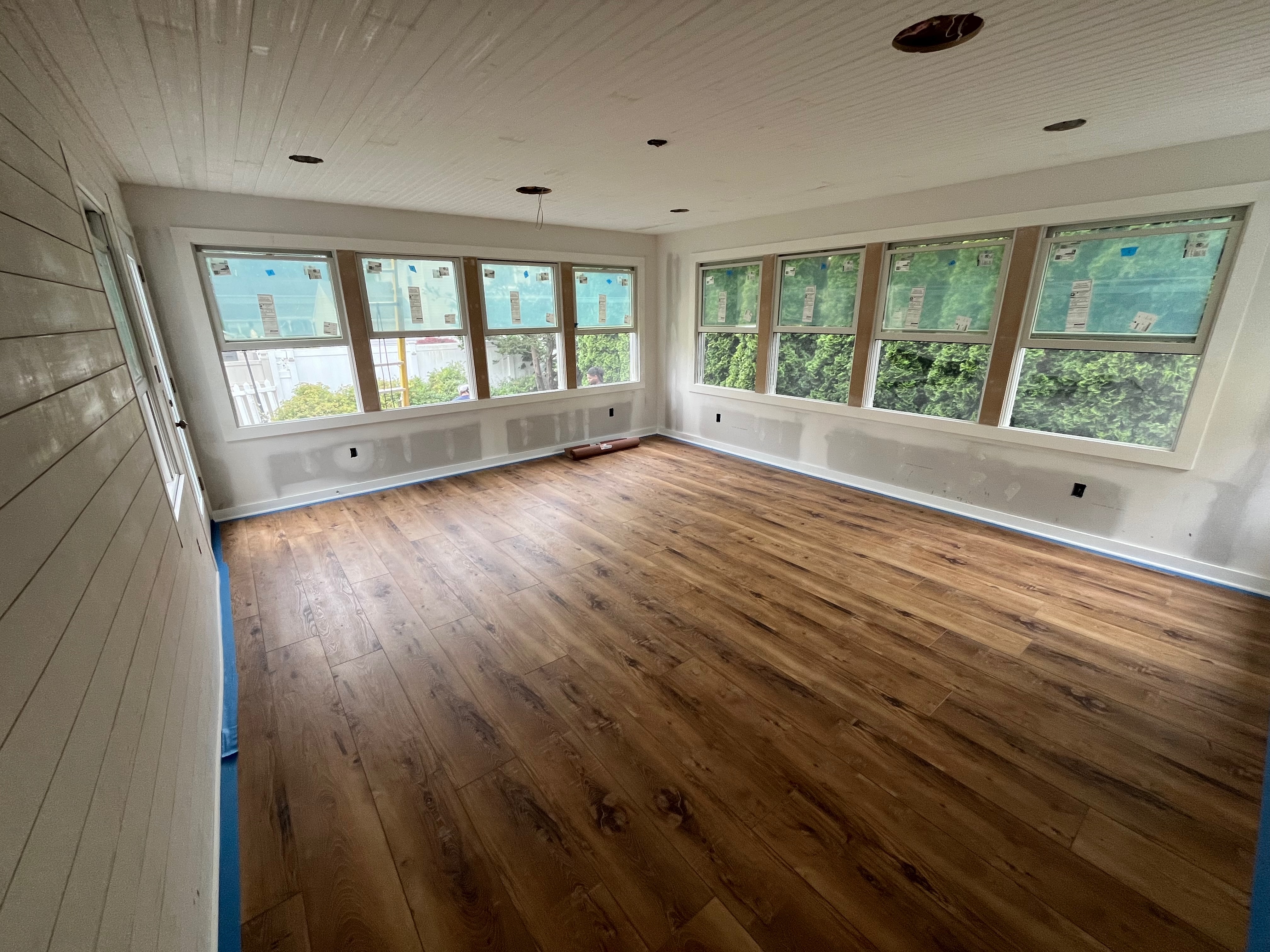 Sunroom addition — new hardwood floors with panoramic windows